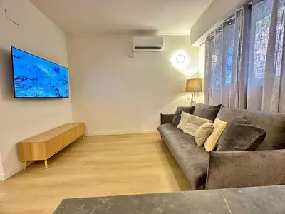 a living room with a couch and a flat screen tv at BarcelonaForRent Sant Pau Suite in Barcelona