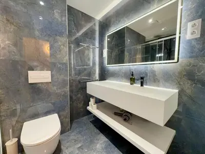 a bathroom with a sink and a toilet and a mirror at BarcelonaForRent Sant Pau Suite in Barcelona