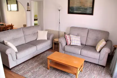 a living room with two couches and a coffee table at Apartamento con Licencia en Sitges in Sitges