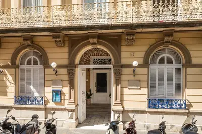 a building with motorcycles parked in front of it at Hotel Medium Renaixença in Sitges