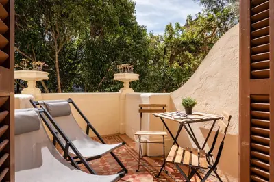 a patio with two chairs and a table at Hotel Medium Romantic in Sitges