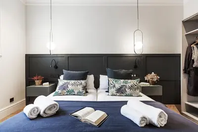 a bedroom with a large bed with towels on it at Weflating City Center in Barcelona