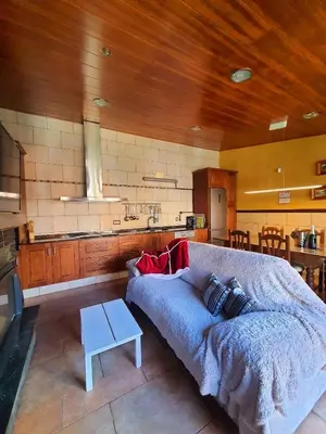 a living room with a couch and a kitchen at Raco de Lis in La Torre de Claramunt