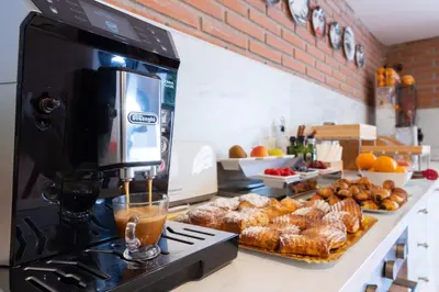 a kitchen with a counter with pastries and a coffee maker at Antonio's House in Sitges