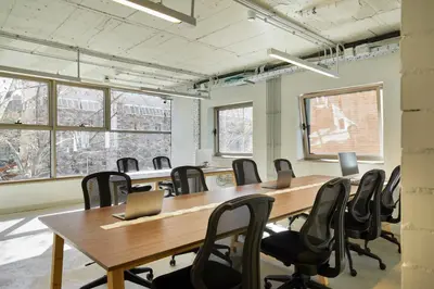 a conference room with a large wooden table and chairs at Unite Hostel Barcelona in Barcelona
