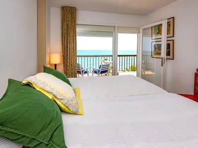 a bedroom with a bed with a view of the ocean at Apartment Acuario by Interhome in Sant Andreu de Llavaneres