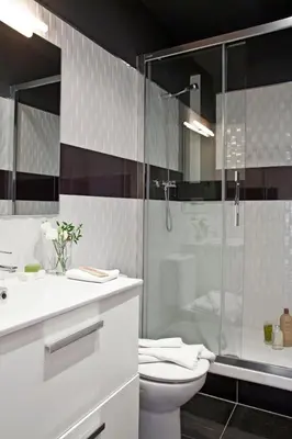 a bathroom with a shower and a toilet and a sink at AinB Eixample-Miro Apartments in Barcelona