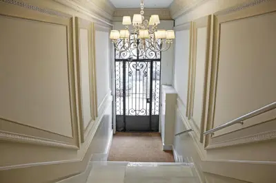 a hallway with a gate and a chandelier at AinB Eixample-Miro Apartments in Barcelona