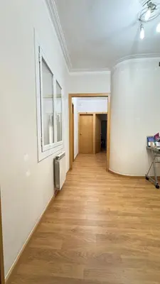 an empty room with a wooden floor and a window at Pensión Laforja in Barcelona
