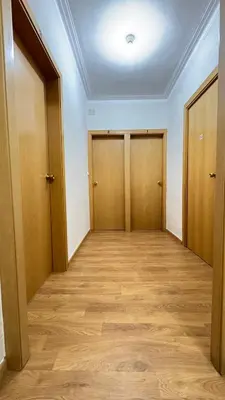 an empty room with two doors and wooden floors at Pensión Laforja in Barcelona
