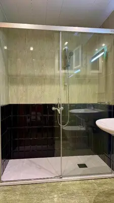 a glass shower in a bathroom with a sink at Pensión Laforja in Barcelona