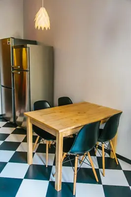 a dining room table with chairs and a refrigerator at ZOOROOMS Boutique Guesthouse in Barcelona