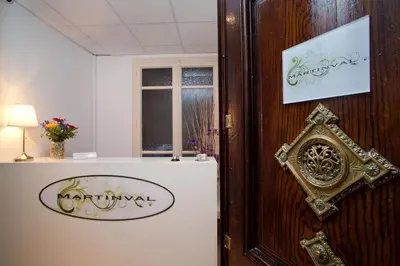 a room with a white refrigerator and a window at Hostal Martinval in Barcelona