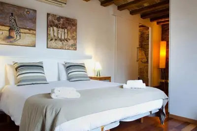 a bedroom with a large white bed with two towels at Ripoll Apartments in Barcelona