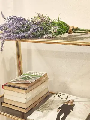 a pile of books sitting on top of a table at Hostal Orleans in Barcelona