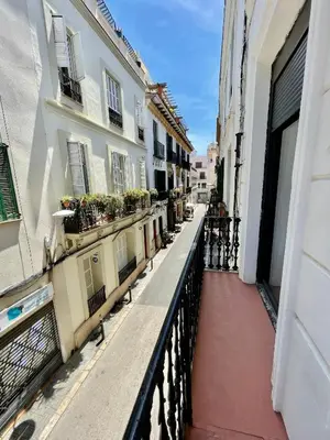 a balcony of a building with plants on it at Madison Rooms in Sitges