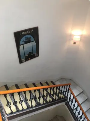 a picture on the wall above a stairway at Madison Rooms in Sitges