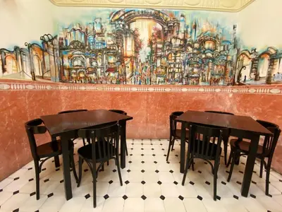 a dining room with two tables and a painting on the wall at Hotel Peninsular in Barcelona