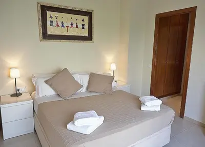 a bedroom with a bed with two towels on it at Alguera Apartments Sant Andreu in Barcelona