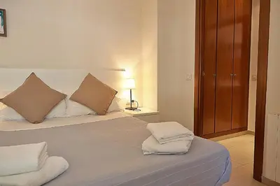 a bedroom with a bed with two pillows on it at Alguera Apartments Sant Andreu in Barcelona