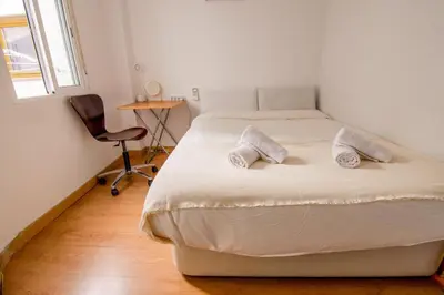 a bedroom with a bed with two pillows on it at Apartament Sagrada Familia in Barcelona