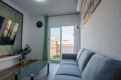 a living room with a couch and a glass table at Apartament Sagrada Familia in Barcelona