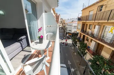 a balcony with a table and chairs on a building at Apartaments Atzavara in Calella