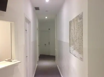 a hallway with a painting on the wall at Hostalin Barcelona Diputacion in Barcelona