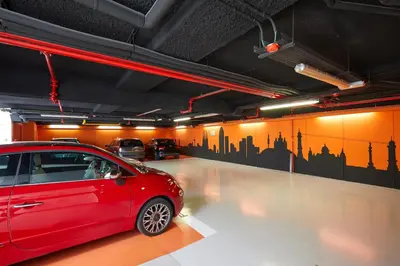 a red car parked in a parking garage at Dorma Plaza Catalunya in Barcelona