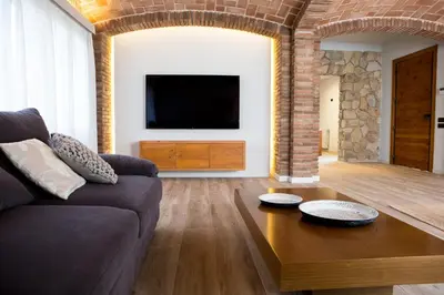 a living room with a couch and a table at Can Cedre in Lliçà d'Amunt