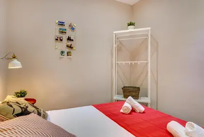 a bedroom with a bed with two towels on it at Renovated & Classic 3-Bedroom Sagrada Familia Apartment in Barcelona