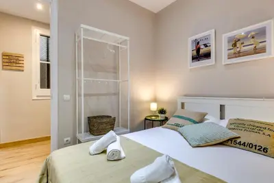 a bedroom with two beds and a window at Renovated & Classic 3-Bedroom Sagrada Familia Apartment in Barcelona