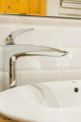 a white bathroom sink with a silver faucet at Novus Homes Barcelona Gracia in Barcelona