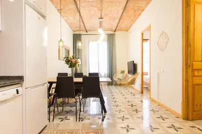 a kitchen and dining room with a table and chairs at Novus Homes Barcelona Gracia in Barcelona