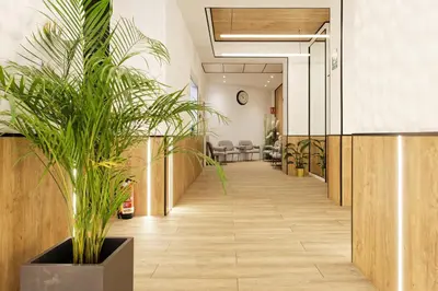 a hallway with a potted plant in a lobby at Green House Hotel in Barcelona