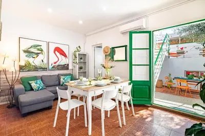 a living room with a table and a couch at CASA FLAMINGO in Masnou