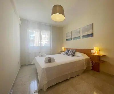 a white bunk bed in a room with a window at HomeHolidaysRentals Salvador in Pineda de Mar