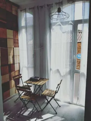 a table and chairs in a room with a window at Dip2 in Barcelona