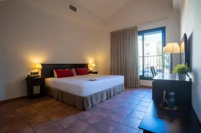 a bedroom with a large bed and a large window at Hotel & Spa Golden Barcelona in Vallromanas