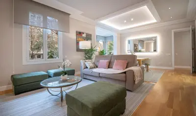 a living room with a couch and a table at You Stylish Diagonal Apartments in Barcelona
