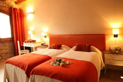a hotel room with two beds with fruit on them at Hotel Rural Can Vila in Sant Esteve de Palautordera