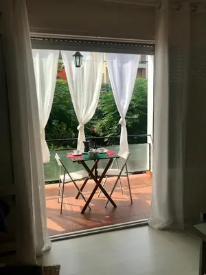 a table sitting in front of a large window at Seaside Apartment in Sitges Steps from Beaches with private Patio in Sitges