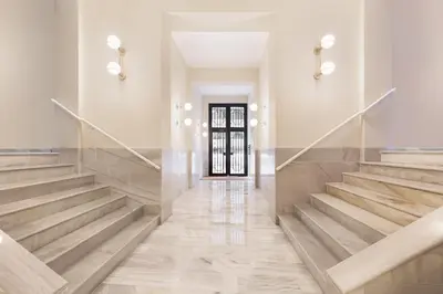 a staircase in a building with wooden floors and a door at Ola Living Diagonal Apartments in Barcelona