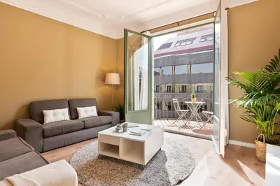 a living room with a couch and a table at Ola Living Diagonal Apartments in Barcelona