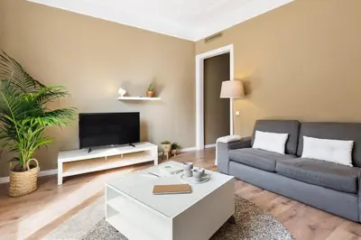 a living room with a couch and a tv at Ola Living Diagonal Apartments in Barcelona