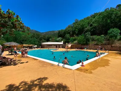 a group of people in a swimming pool at Càmping Parc Gualba in gualba de Dalt