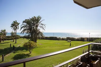 a view of the beach from the balcony of a condo at Relaxing Seafront Apartment Gavà 20 Min from BCN in Gavà