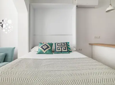 a bedroom with a white bed with pillows on it at Siroco by Seaside Homes in Castelldefels
