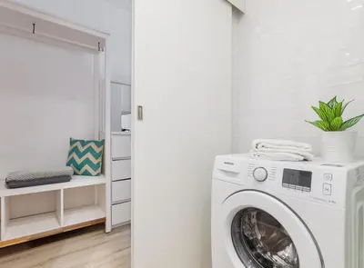 a white laundry room with a washing machine at Siroco by Seaside Homes in Castelldefels