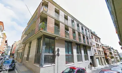 a building on a street with cars parked in front of it at My Space Barcelona Guell Terrace Center in Barcelona